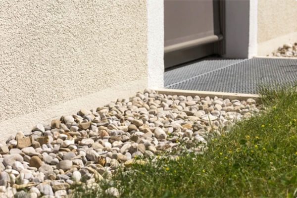 Perimeter French drain with a decorative stone finish protecting an Orlando home foundation from hydrostatic pressure.