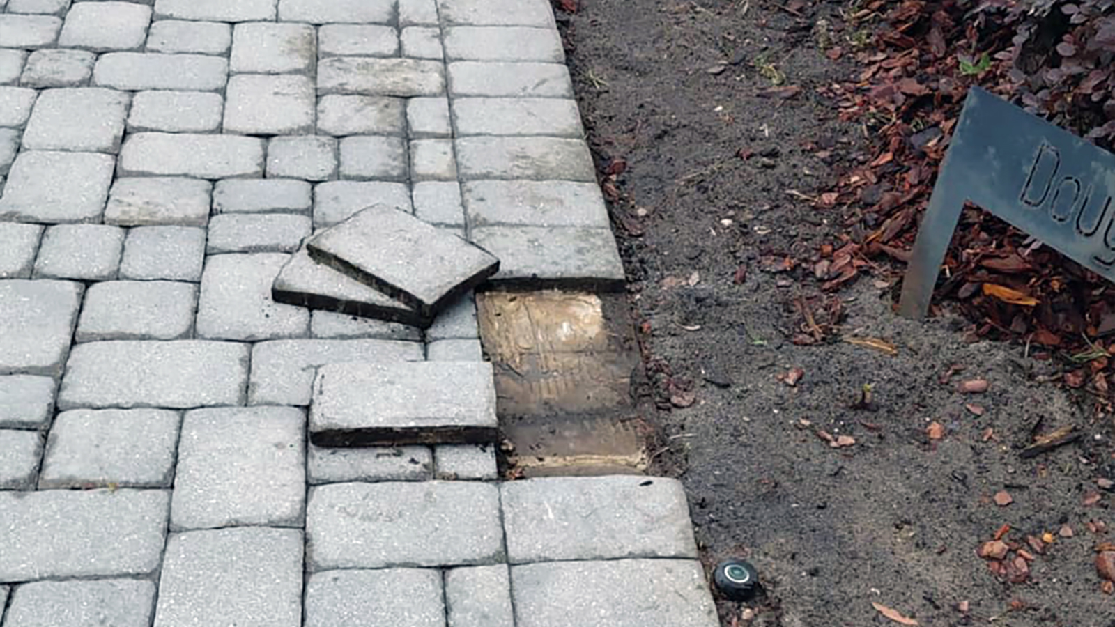 Failed paver walkway overlay with loose and shifted pavers in Lake Mary Florida showing base exposure and structural breakdown